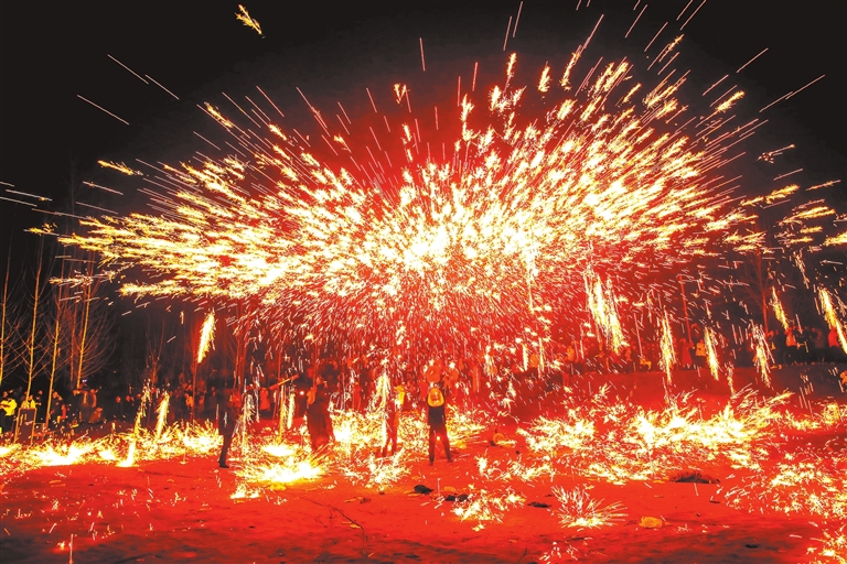 2月13日,尉氏县南曹乡的民间艺人正在荣村庙会上表演"打铁花".